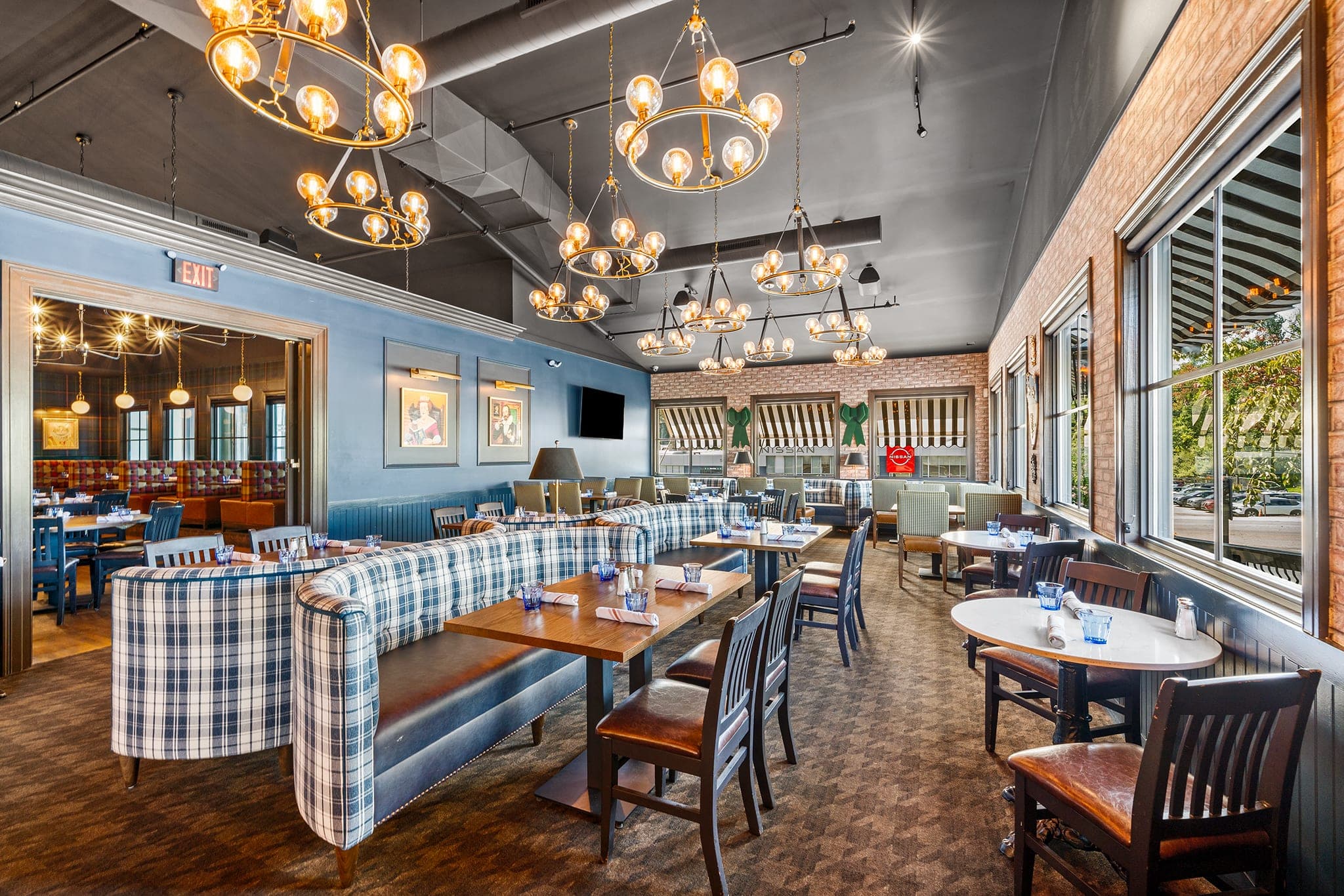 The Library dining room with tartan banquettes and chandeliers at Crown Tavern in Glen Mills, PA
