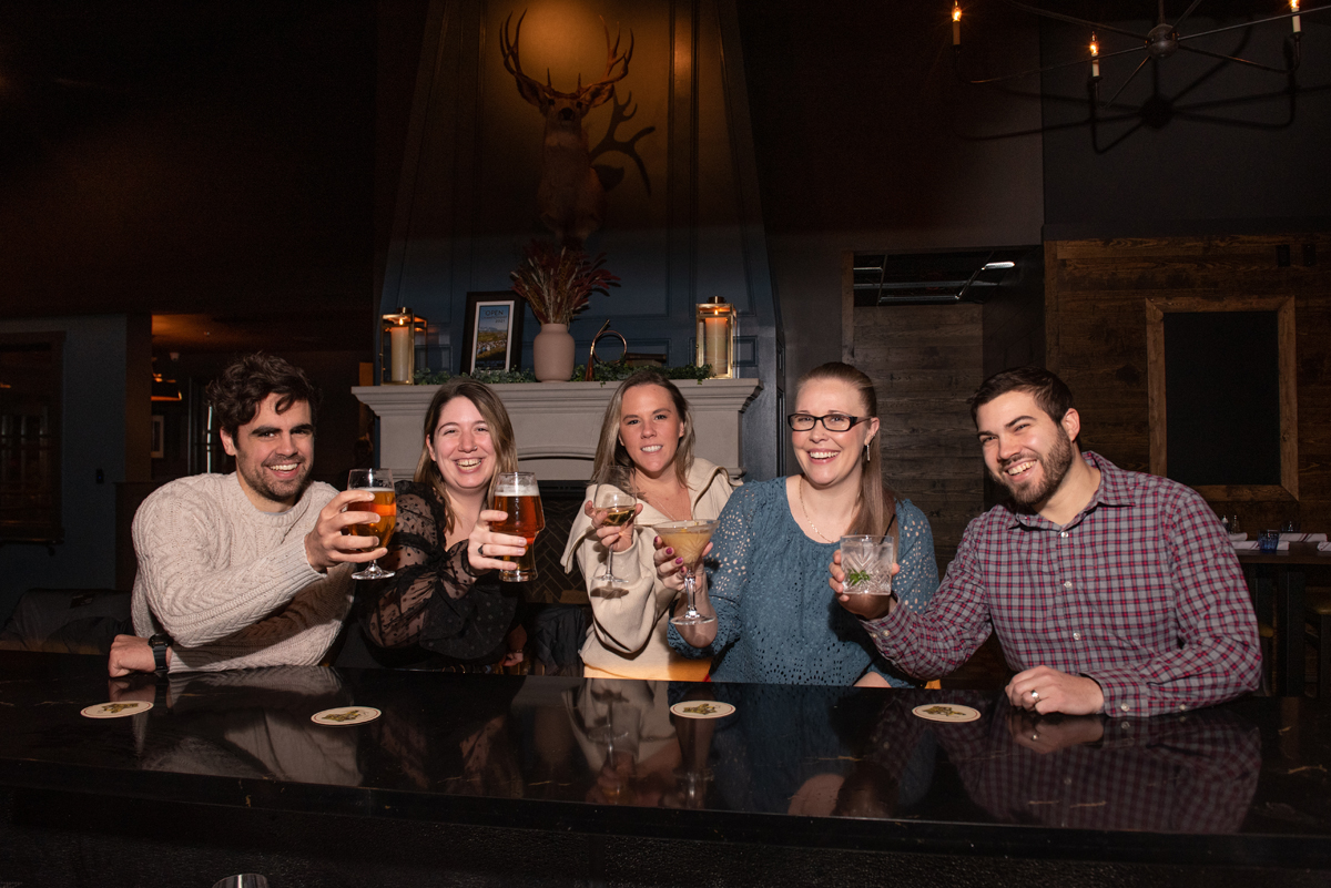 People celebrating with beers and cocktails at a fun event